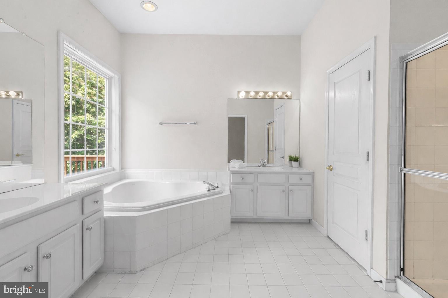 119 Violet Drive Kennett Square, PA 19348 - Photo 14 of 22 a bathroom with a granite countertop tub a sink and a window