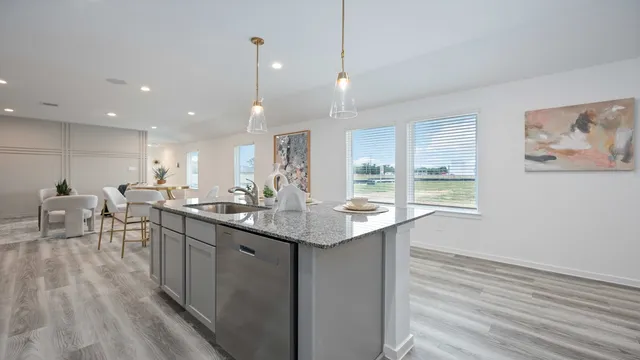 a kitchen with center island with wooden floor