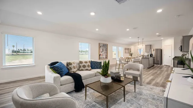 a living room with furniture kitchen and a table