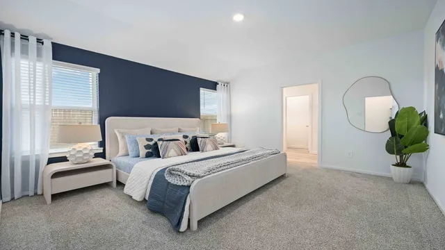 a bed room with a bed mirror and a potted plant