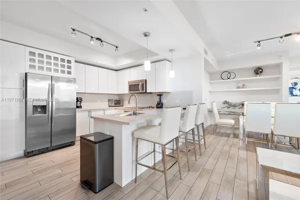 a kitchen with stainless steel appliances kitchen island granite countertop a sink and cabinets