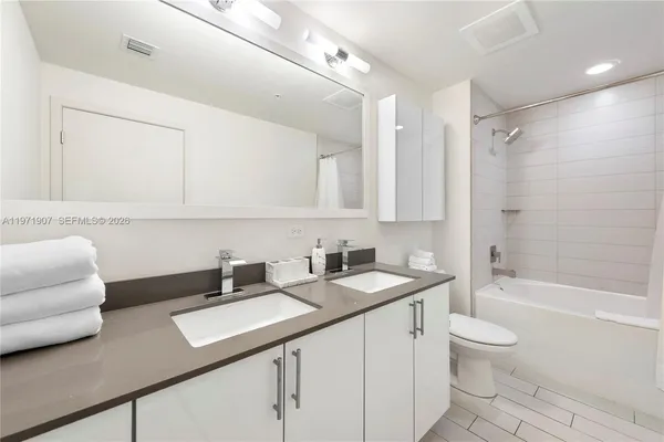 a bathroom with a sink a toilet and a bathtub