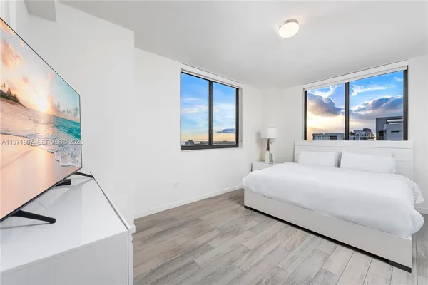 a bedroom with a large bed and a window