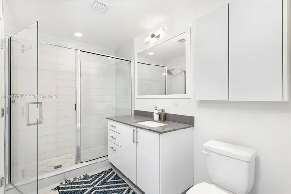 a bathroom with a sink toilet and shower