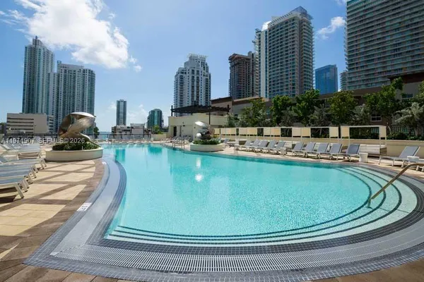 a view of a swimming pool with outdoor seating