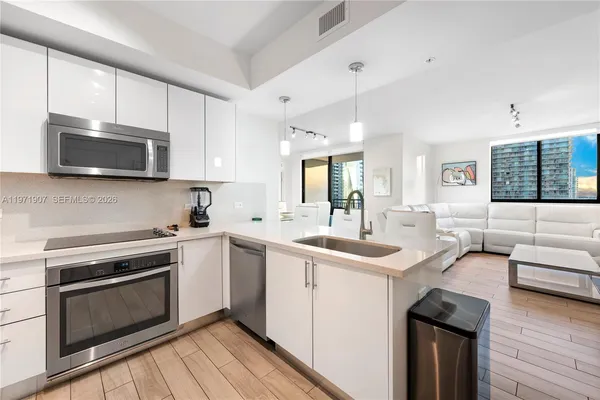 a kitchen with a sink stove and microwave