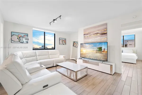 a living room with furniture wooden floor and window