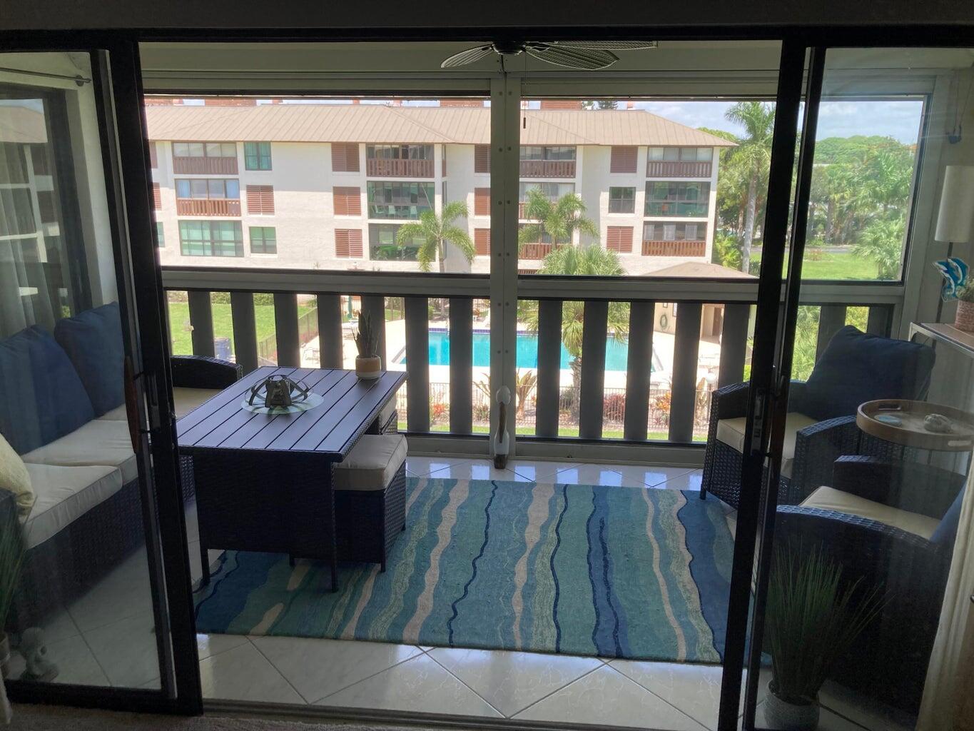 166 Southeast St Lucie Boulevard, Unit D404 Stuart, FL 34996 - Photo 13 of 14 a view of a wooden bench in balcony