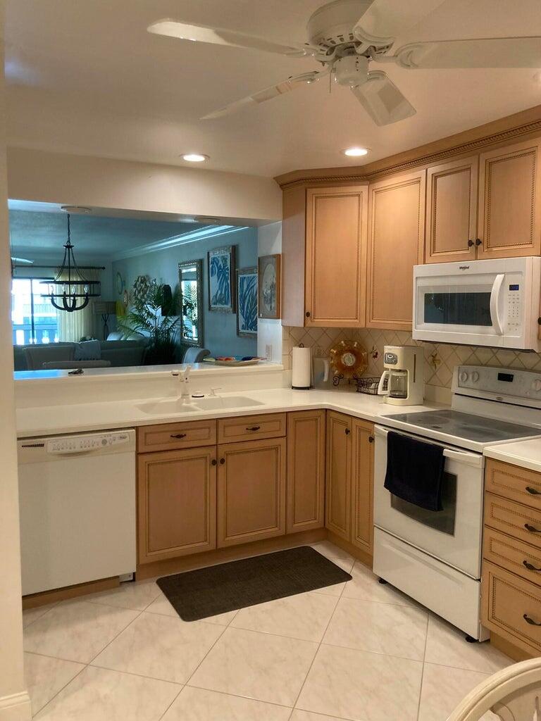 166 Southeast St Lucie Boulevard, Unit D404 Stuart, FL 34996 - Photo 4 of 14 a kitchen with a sink cabinets and window