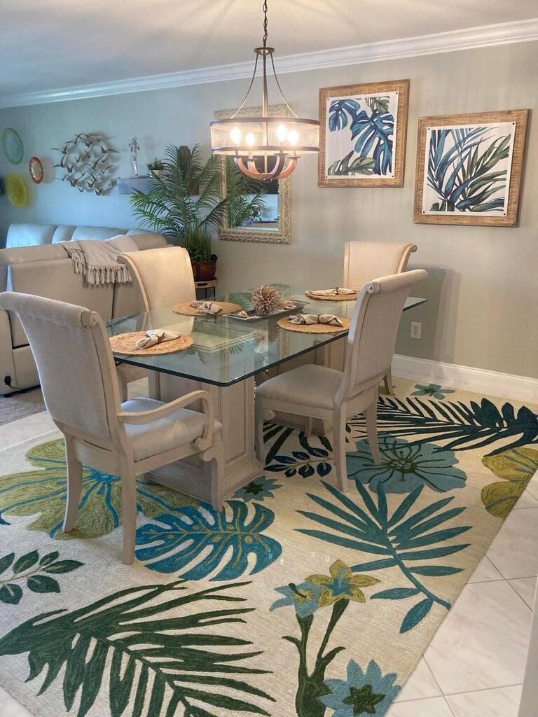 166 Southeast St Lucie Boulevard, Unit D404 Stuart, FL 34996 - Photo 6 of 14 a view of a dining room with furniture