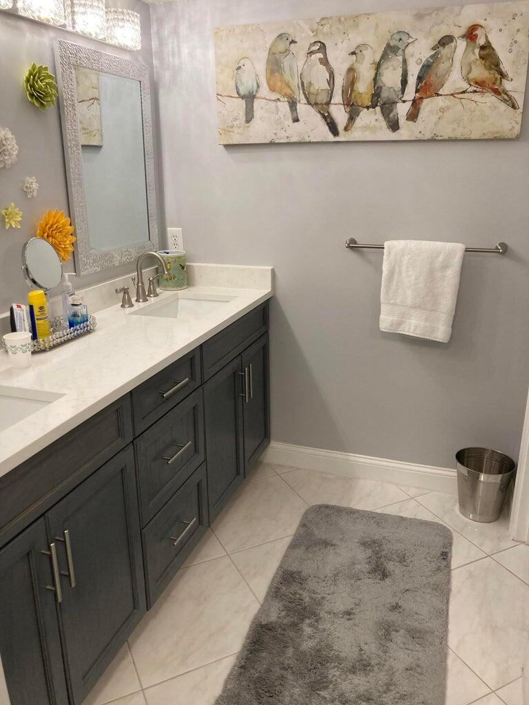 166 Southeast St Lucie Boulevard, Unit D404 Stuart, FL 34996 - Photo 9 of 14 a bathroom with a sink and mirror