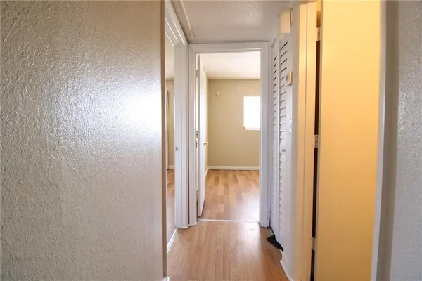a view of a hallway with wooden floor