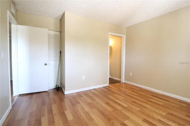 a view of an empty room with wooden floor