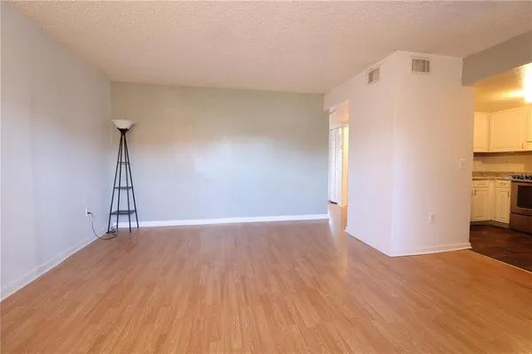 a view of a livingroom with wooden floor and a ceiling fan