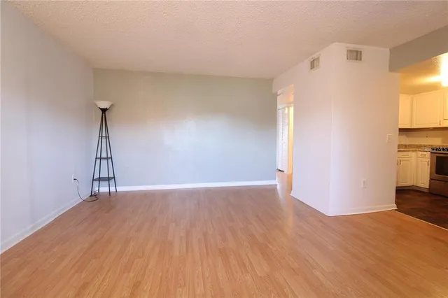 a view of a livingroom with wooden floor and a ceiling fan