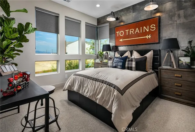 a bedroom with a bed and a window with the outer view