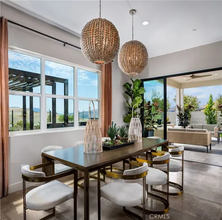 a view of a dining room with furniture wooden floor and a chandelier