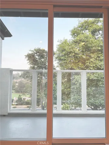 a view of a room with a large window and bed