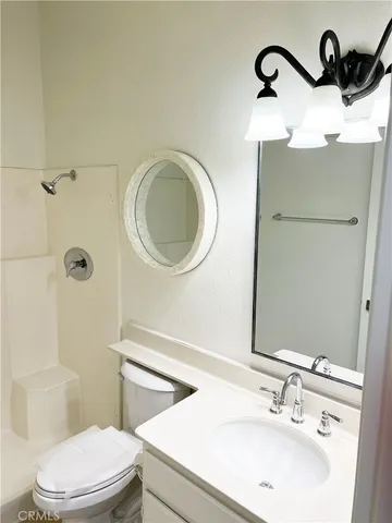 a bathroom with a sink a toilet and a mirror