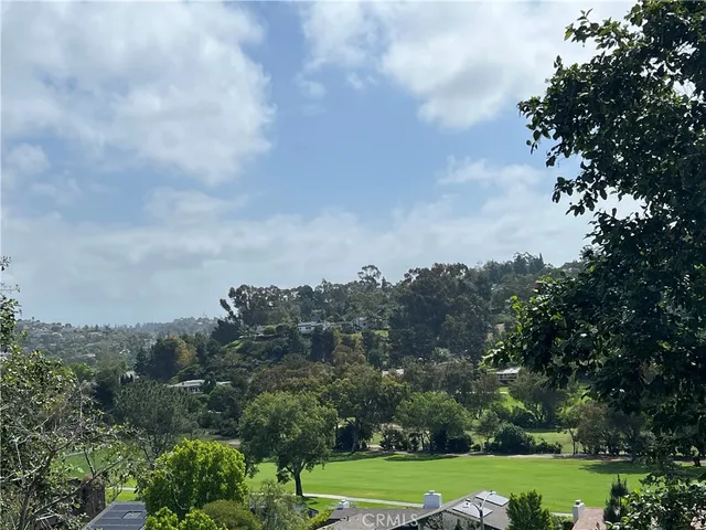an aerial view of a golf course with seating space