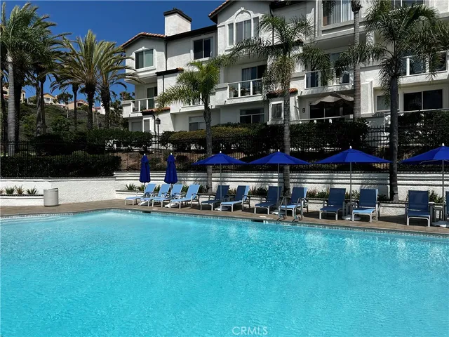 a view of street with shops and palm trees