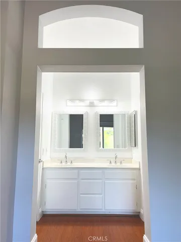 a bathroom with a sink mirror and a bathtub