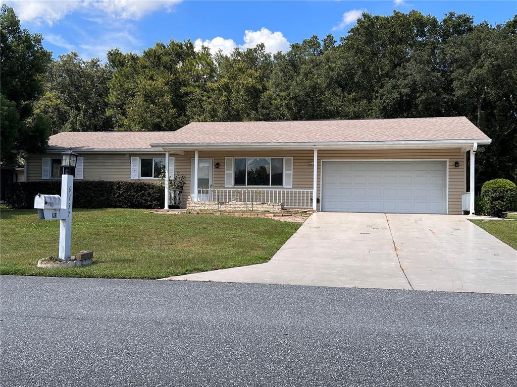 6137 Southwest 63rd Street Ocala, FL 34474 - Photo 1 of 1 a front view of a house with a yard and garage