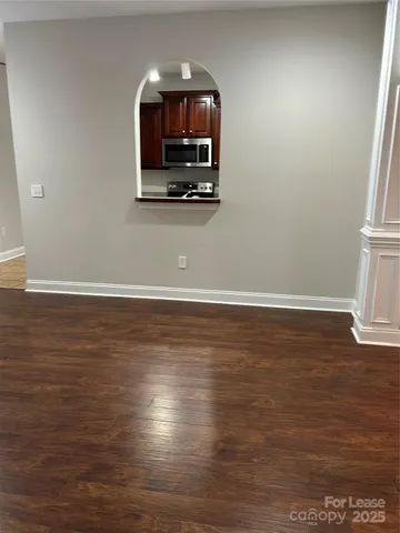 a room with wooden floor and a flat screen tv