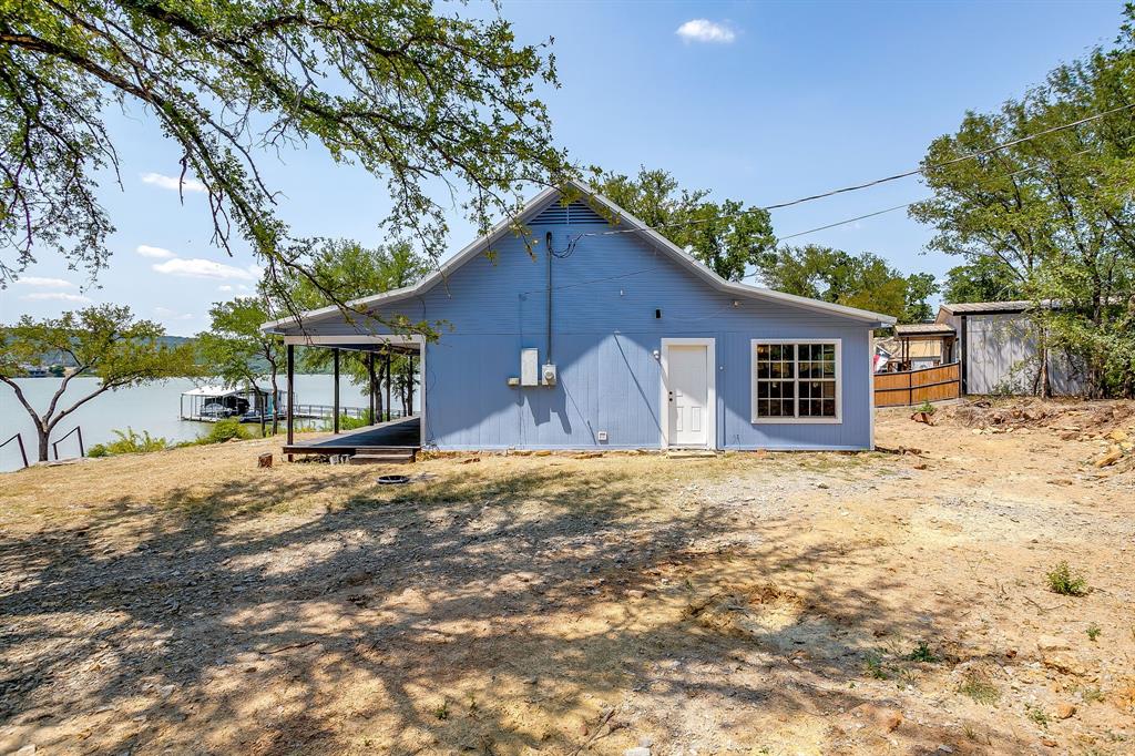 1048 Kennon Point Palo Pinto, TX 76484 - Photo 12 of 16 a front view of a house with a yard and garage