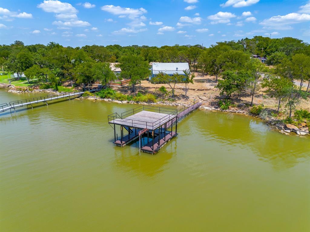 1048 Kennon Point Palo Pinto, TX 76484 - Photo 16 of 16 a view of a lake with lawn chairs