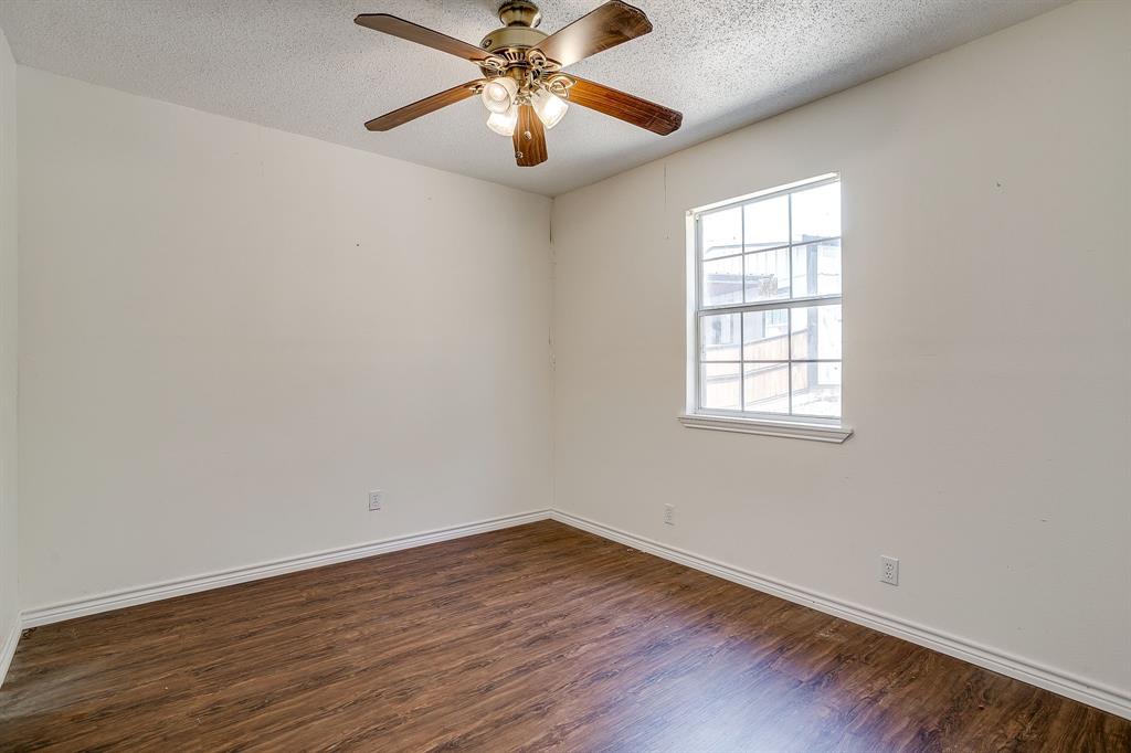 1048 Kennon Point Palo Pinto, TX 76484 - Photo 7 of 16 an empty room with wooden floor fan and windows