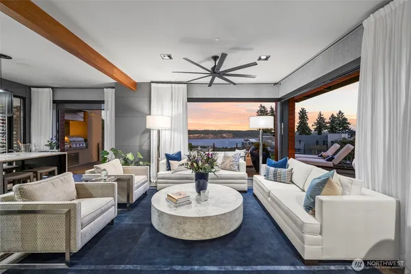 a living room with fireplace furniture and a large window