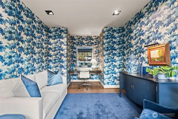 a bedroom with furniture and a painting on the wall
