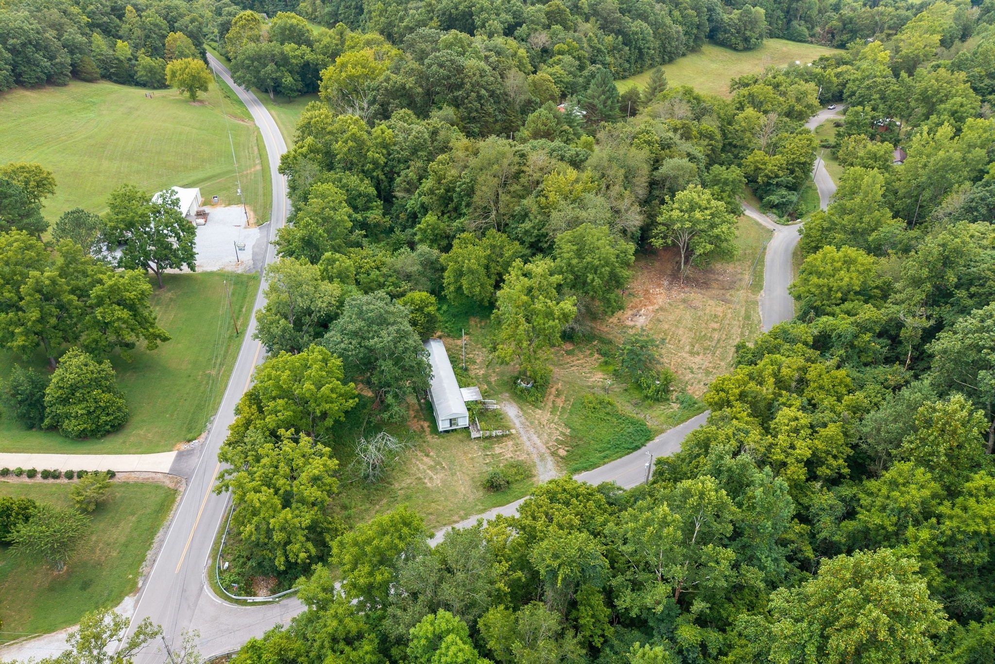 an aerial view of a house with a yard and lake view