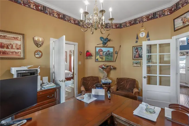 a view of a dining room with furniture wooden floor and chandelier