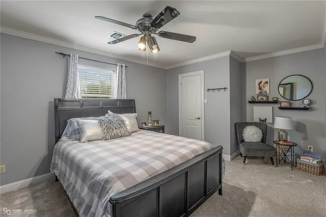 a bedroom with a large bed and a chandelier