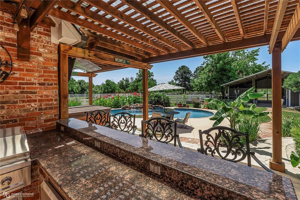 1171 Wemple Road Bossier City, LA 71111 - Photo 21 of 31 Fenced backyard featuring a patio, exterior kitchen, and a pergola