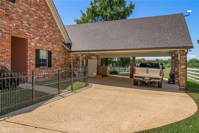 an aerial view of a house with a yard swimming pool and outdoor seating