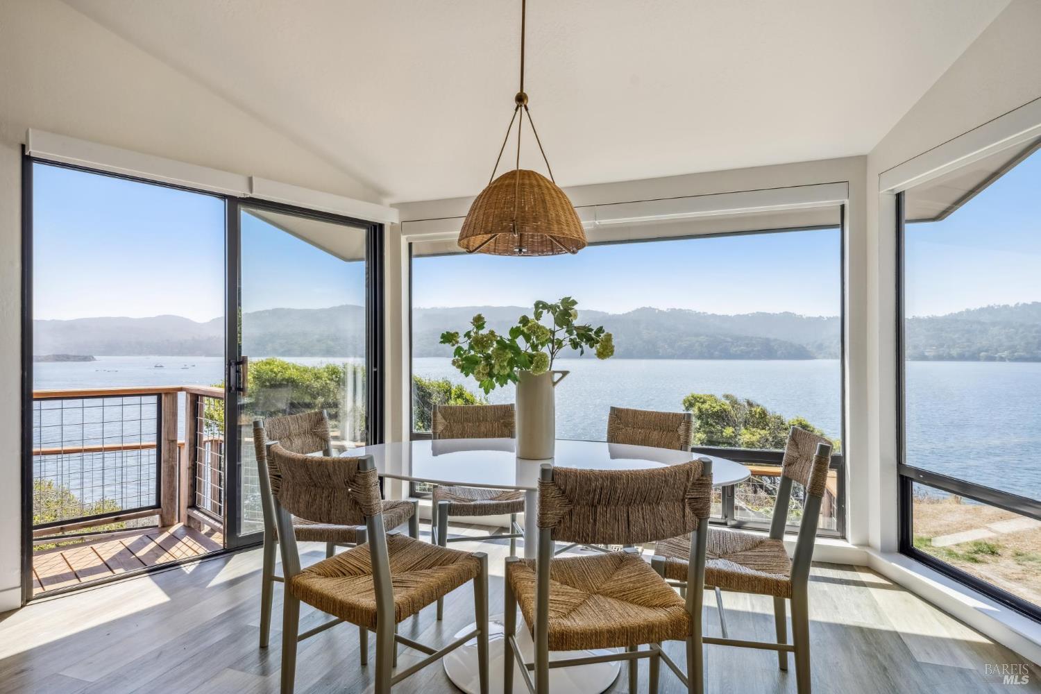 17523 Highway 1 Marshall, CA 94940 - Photo 15 of 72 a dining room with furniture and wooden floor