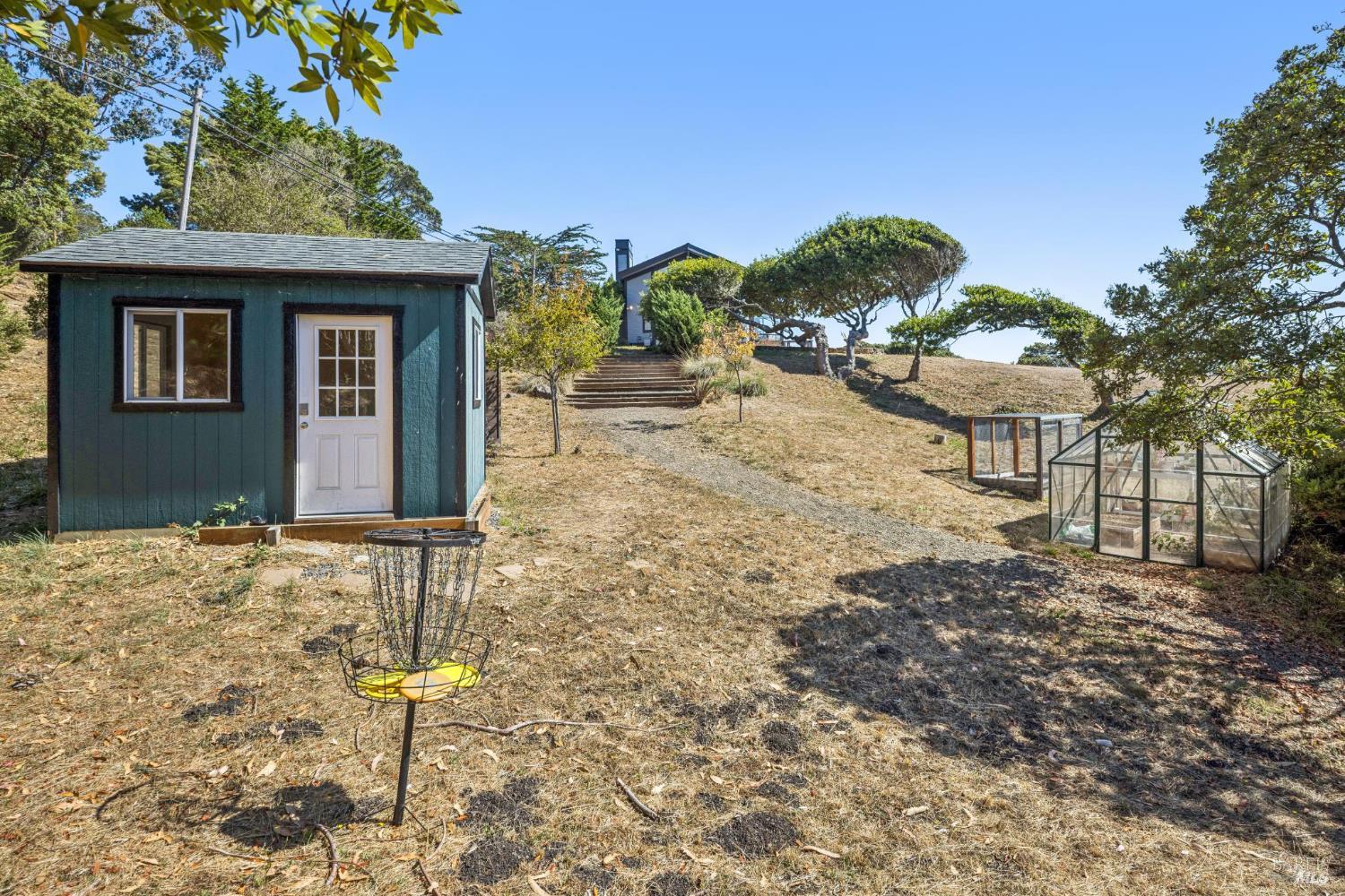 17523 Highway 1 Marshall, CA 94940 - Photo 35 of 72 a front view of a house with a yard and garage