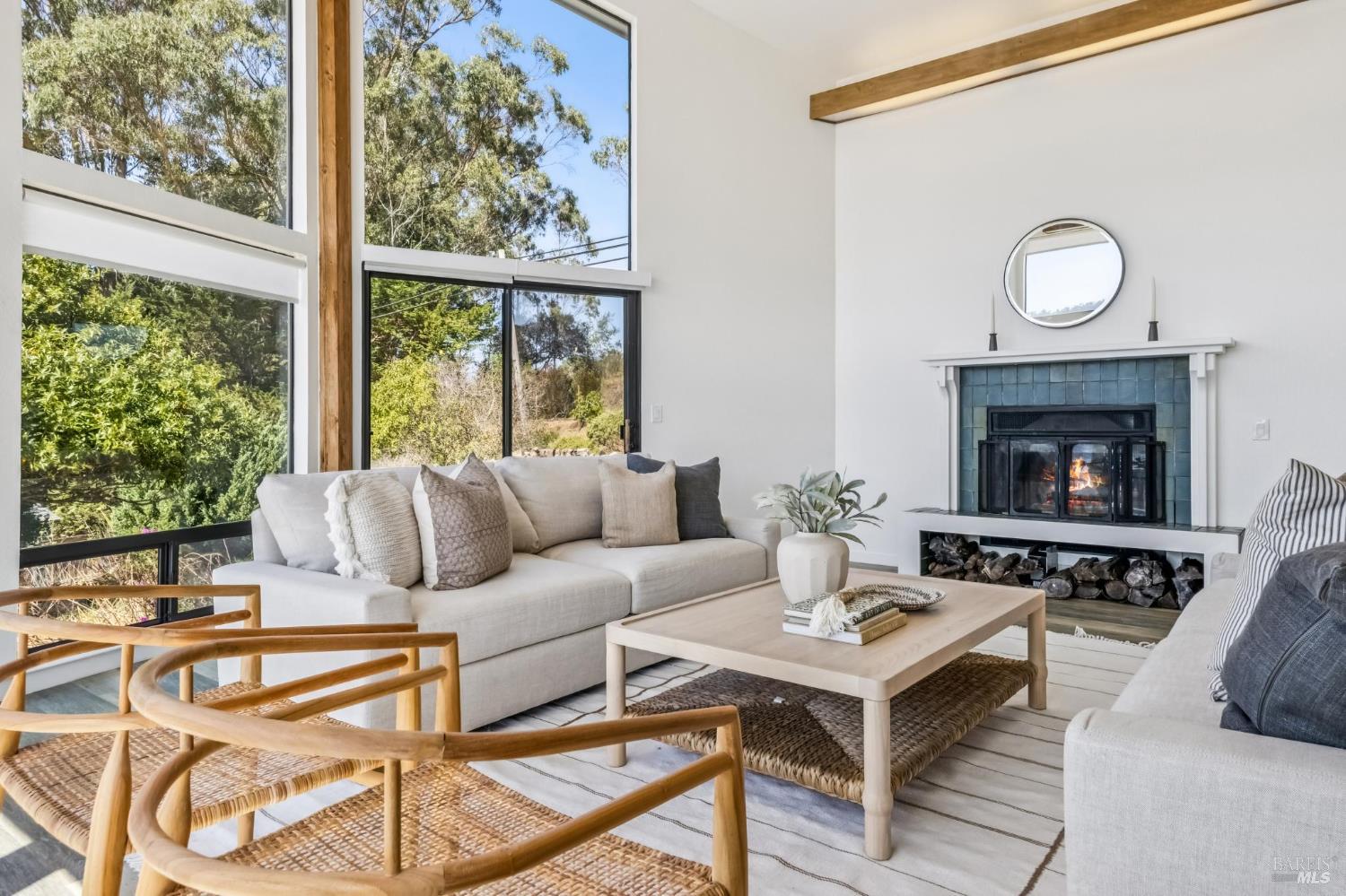17523 Highway 1 Marshall, CA 94940 - Photo 7 of 72 a living room with a couch a fireplace and a large window