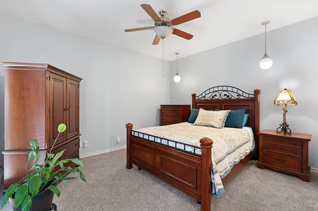 a bedroom with a bed and a chandelier