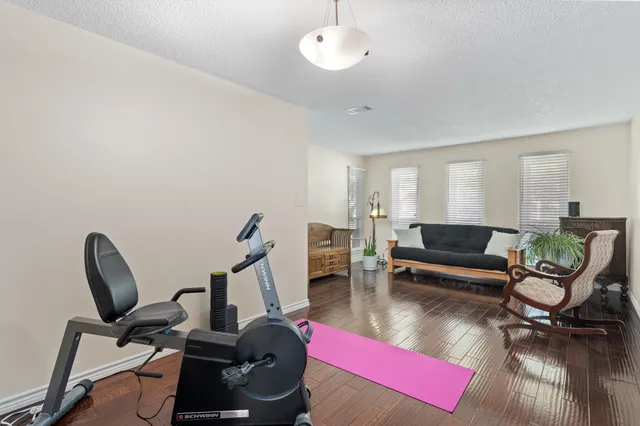 a living room with furniture a rug and a piano