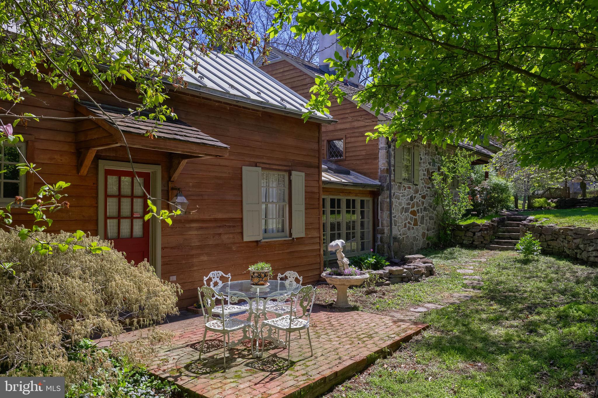 705 Schoffers Road Birdsboro, PA 19508 - Photo 37 of 106 a view of a patio with table and chairs and potted plants