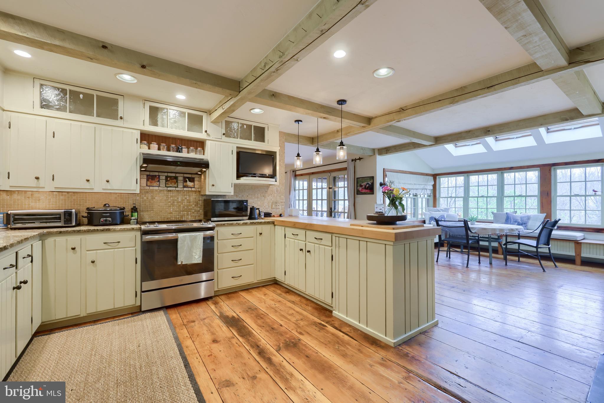 705 Schoffers Road Birdsboro, PA 19508 - Photo 53 of 106 a kitchen with stainless steel appliances granite countertop a stove a sink dishwasher and a refrigerator with wooden floor