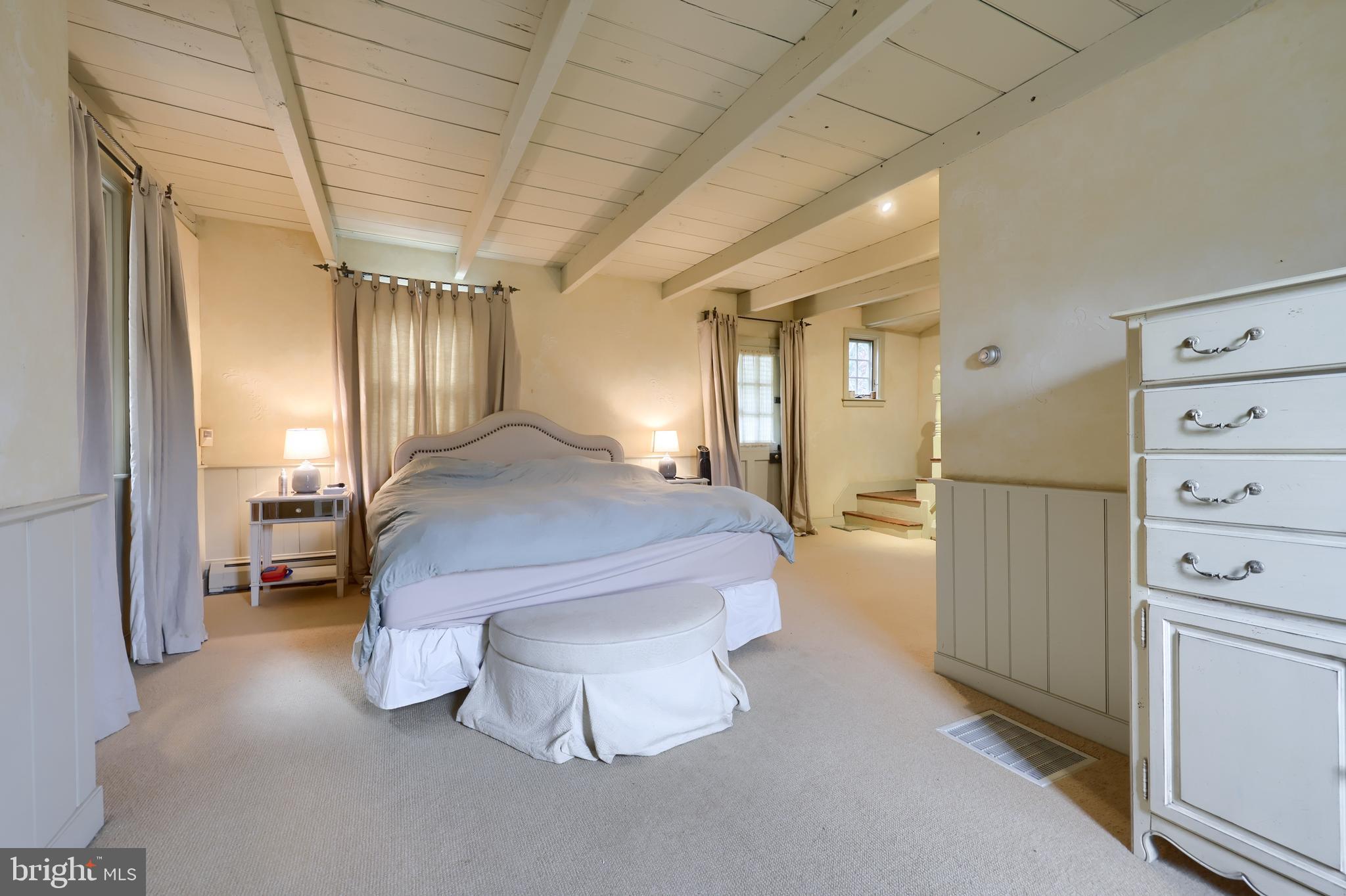 705 Schoffers Road Birdsboro, PA 19508 - Photo 73 of 106 a spacious bedroom with a bed and closet with mirror
