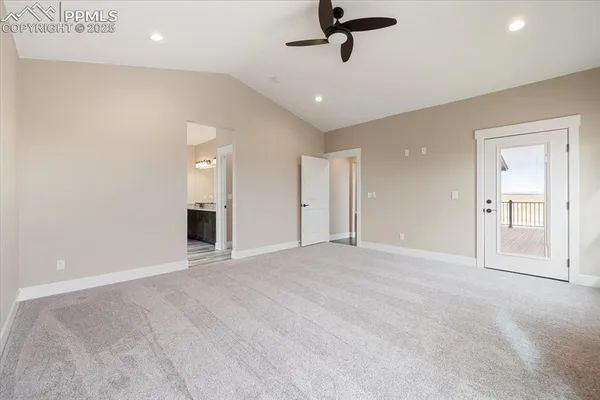a view of an empty room and a ceiling fan