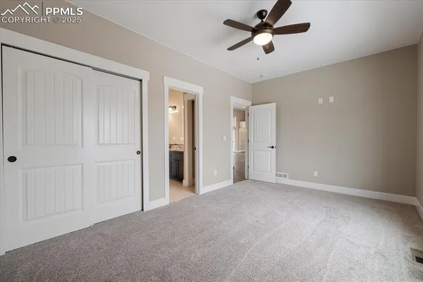 a view of a room with a ceiling fan and a ceiling fan