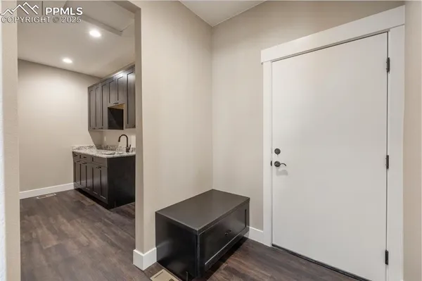a view of a hallway with bathroom and wooden floor