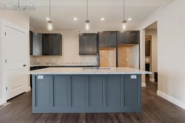 a bathroom with a sink a large mirror and cabinets